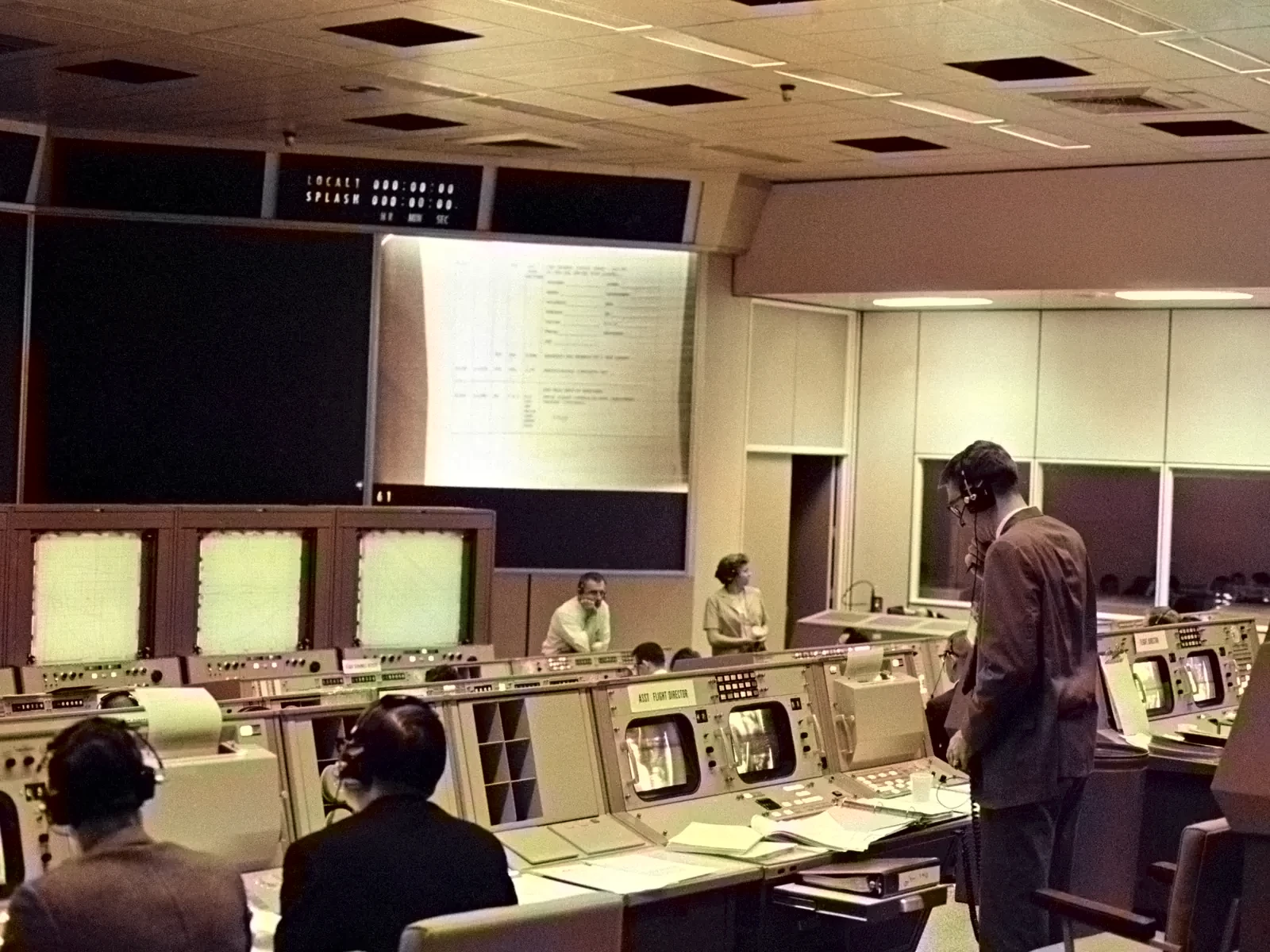Rows of consoles in Mission Control, Houston, in 1965, with flight controllers at work.