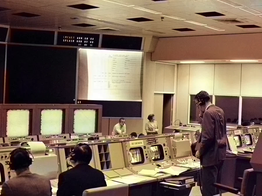 Rows of consoles in Mission Control, Houston, in 1965, with flight controllers at work.