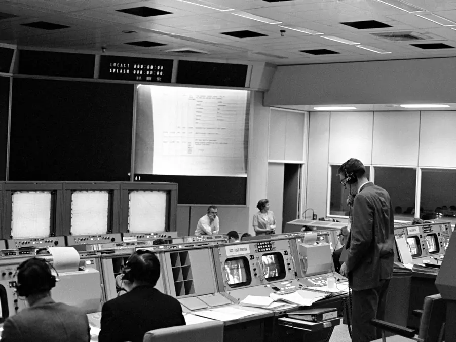 Rows of consoles in Mission Control, Houston, in 1965, with flight controllers at work.